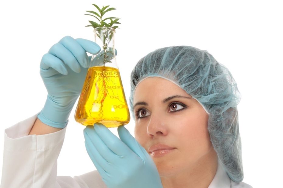 mulher segurando planta em laboratório